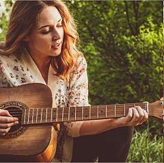 Female playing Guitar
